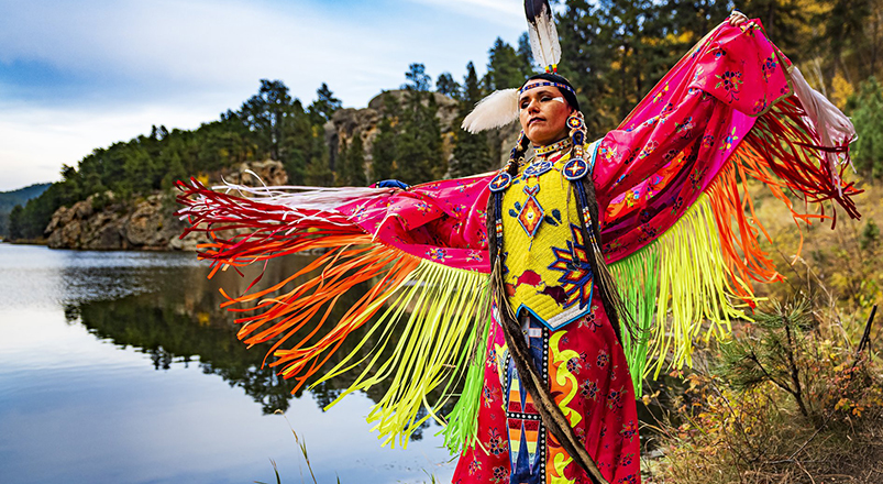 native-american-woman next to the lake