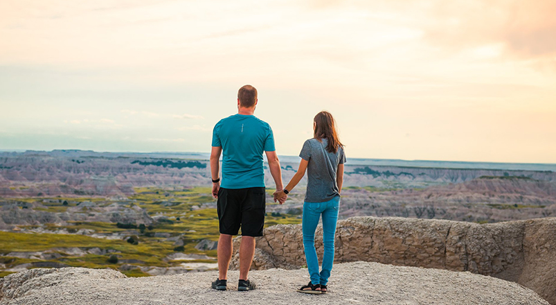 man-and-woman-holding-hands-at-badlands
